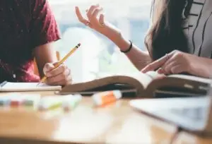 Students studying together with textbooks