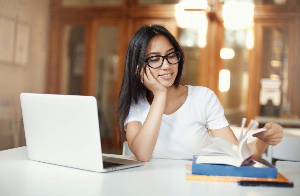 Student studying with a laptop and notes